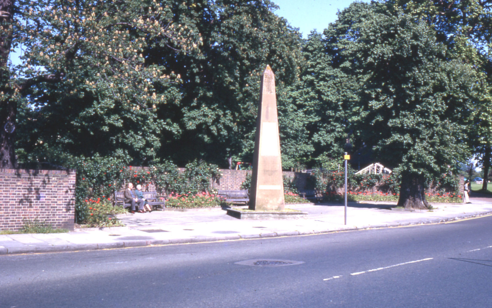 The Obelisk, Cricket Green, Mitcham, Surrey CR4. Erected by the Rev. Richard Cramer. who lived at the Canons until 1824. when he became vicar of Mitcham. 