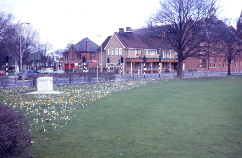 Corner of Cricket Green, Mitcham, Surrey CR4. Tom Ruff memorial and crocuses. the Vestry Hall in background.