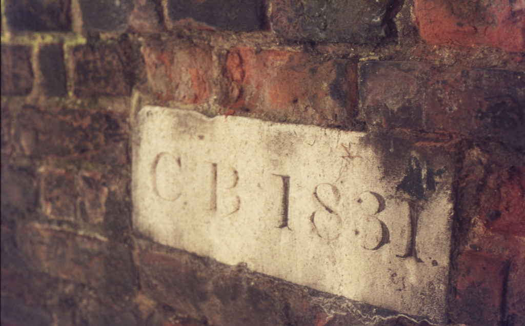 9 Cricket Green, Mitcham, Surrey CR4. Dated (1831) stone in garden wall.